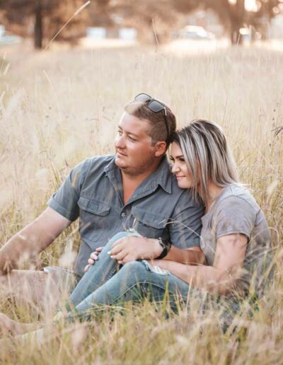 Couple photography: A romantic image featuring a loving couple, embracing or holding hands, with genuine smiles and laughter, set against a beautiful outdoor backdrop or cozy indoor setting, reflecting the bond and affection between them.