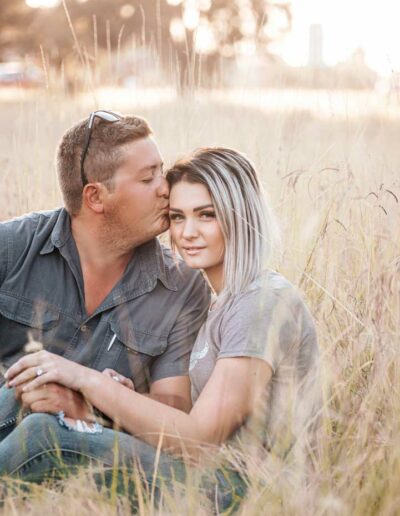 Couple photography: A romantic image featuring a loving couple, embracing or holding hands, with genuine smiles and laughter, set against a beautiful outdoor backdrop or cozy indoor setting, reflecting the bond and affection between them.