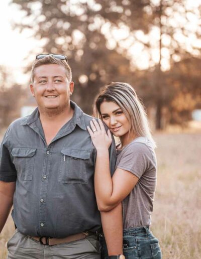 Couple photography: A romantic image featuring a loving couple, embracing or holding hands, with genuine smiles and laughter, set against a beautiful outdoor backdrop or cozy indoor setting, reflecting the bond and affection between them.