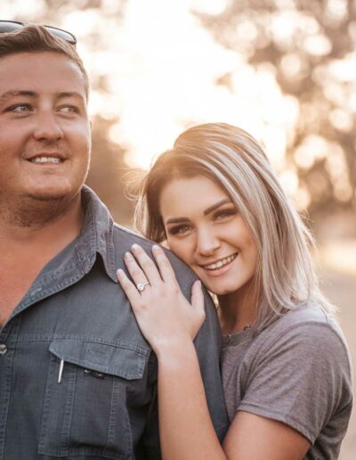 Couple photography: A romantic image featuring a loving couple, embracing or holding hands, with genuine smiles and laughter, set against a beautiful outdoor backdrop or cozy indoor setting, reflecting the bond and affection between them.