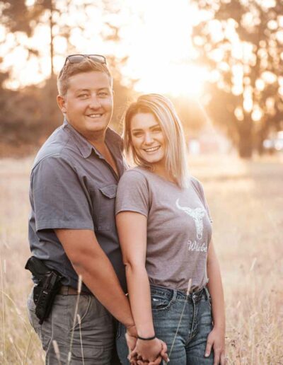 Couple photography: A romantic image featuring a loving couple, embracing or holding hands, with genuine smiles and laughter, set against a beautiful outdoor backdrop or cozy indoor setting, reflecting the bond and affection between them.